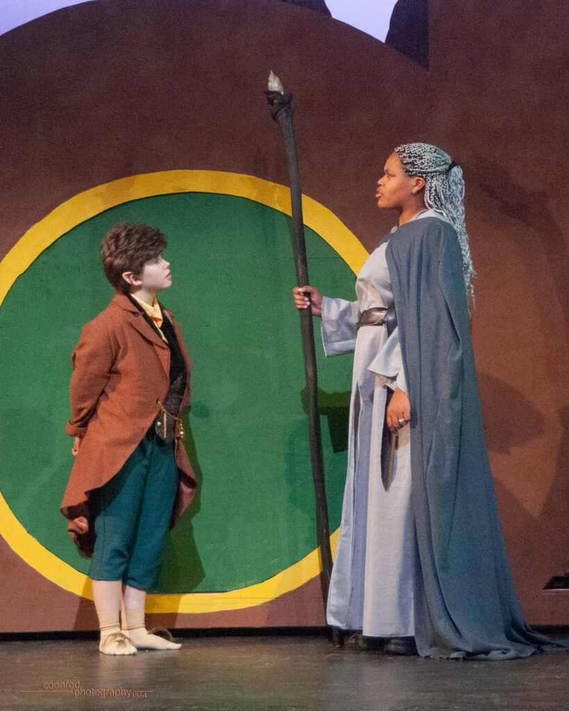 Two actors portraying Bilbo and Gandalf in a performance of The Hobbit